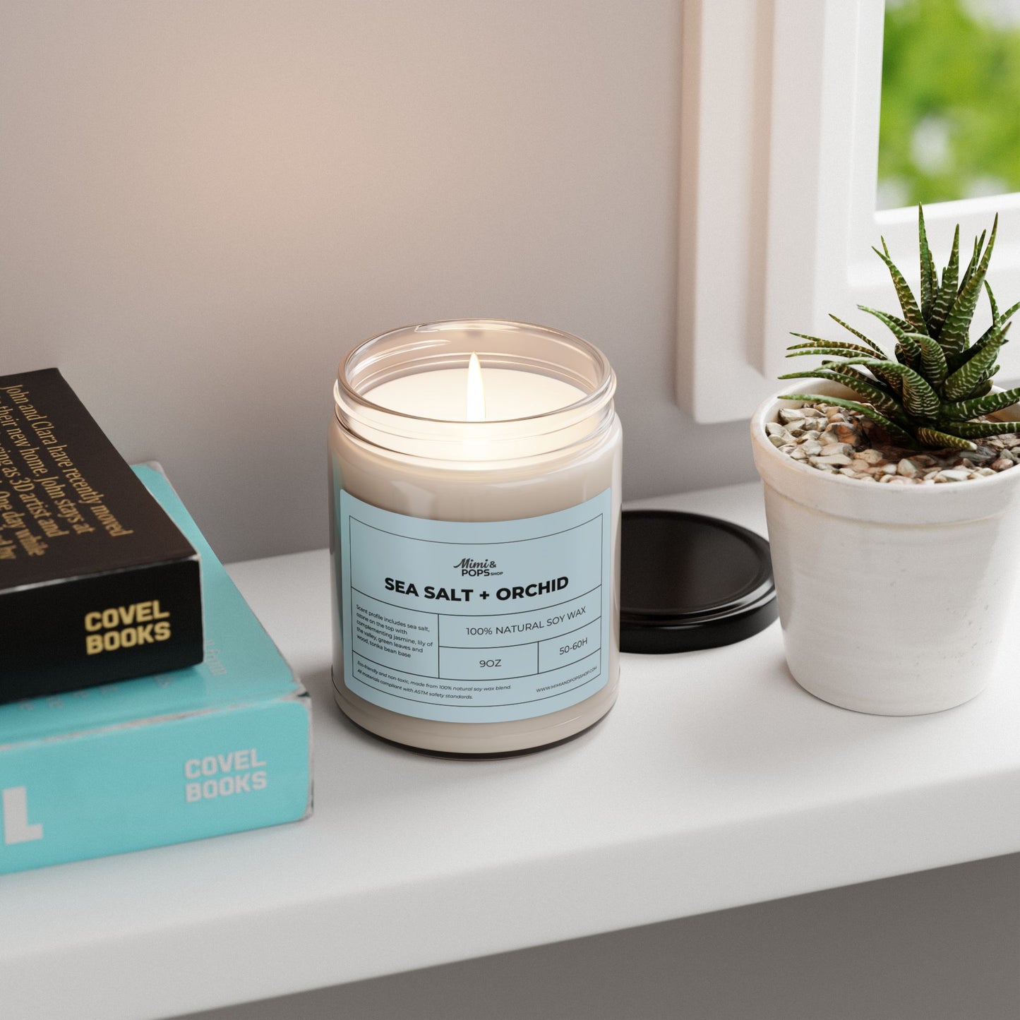 9oz Sea Salt and Orchid Soy Candle on wooden table with coastal decor